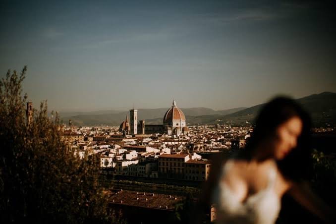 A bride overlooking Florence's skyline and the Duomo at golden hour