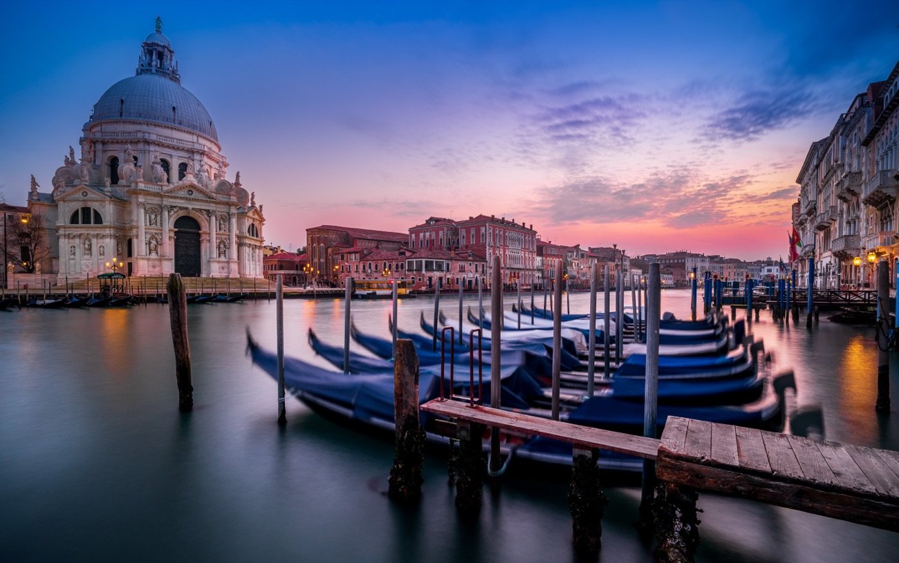 Santa Maria della Salute and gondolas on Venice's Grand Canal at blue hour